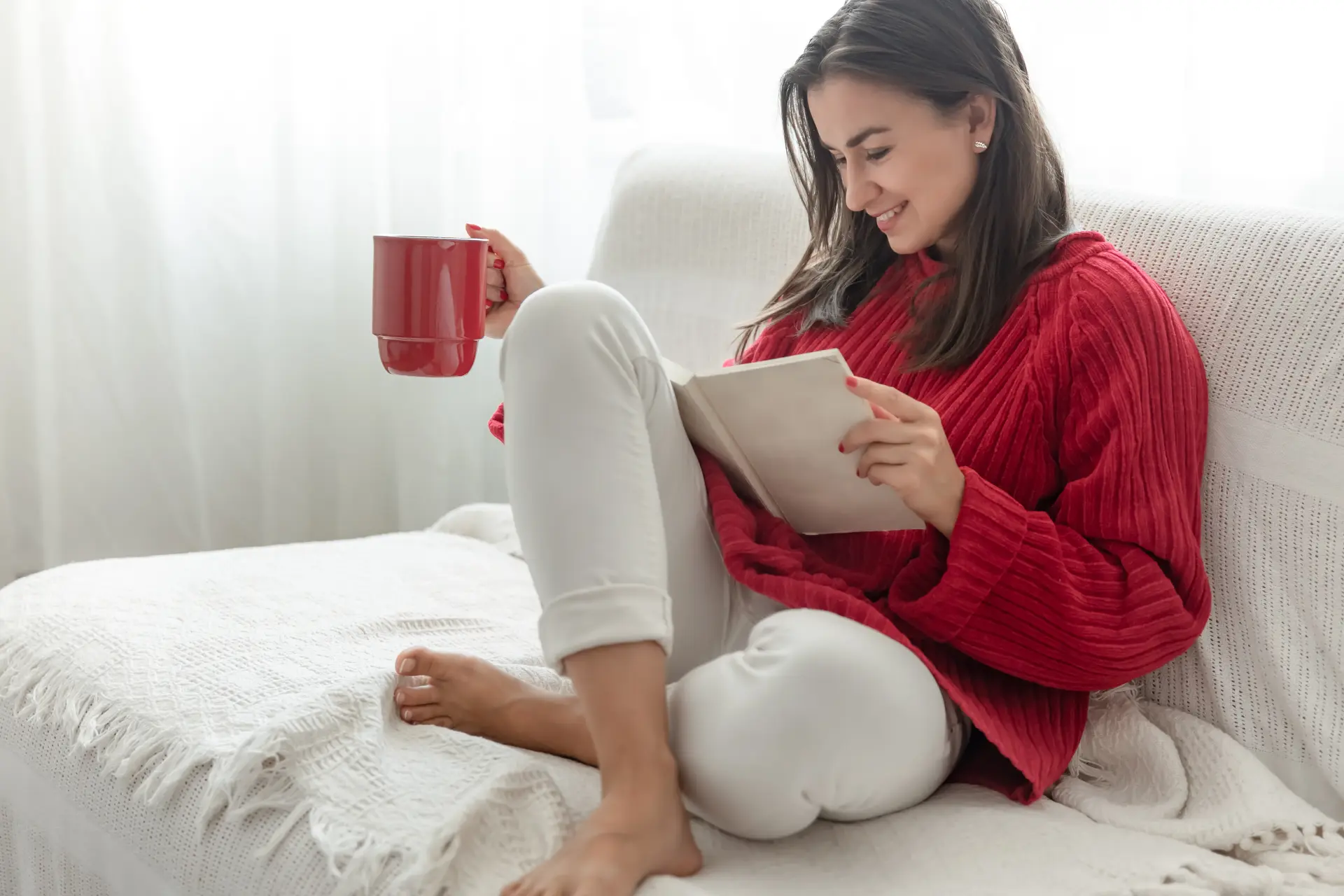 12063721_young-woman-red-sweater-with-red-cup-reads-book